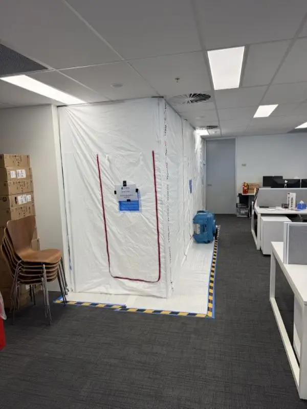 Full containment system installed in office with floor protection and HEPA air filtration unit